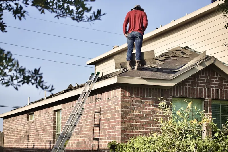Professional roofer working on a residential roof in Saw Mill Valley